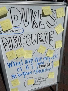 Dukes Discourse white board on Warner Commons. What are the impacts of AI and higher education? Lots of sticky note responses! 